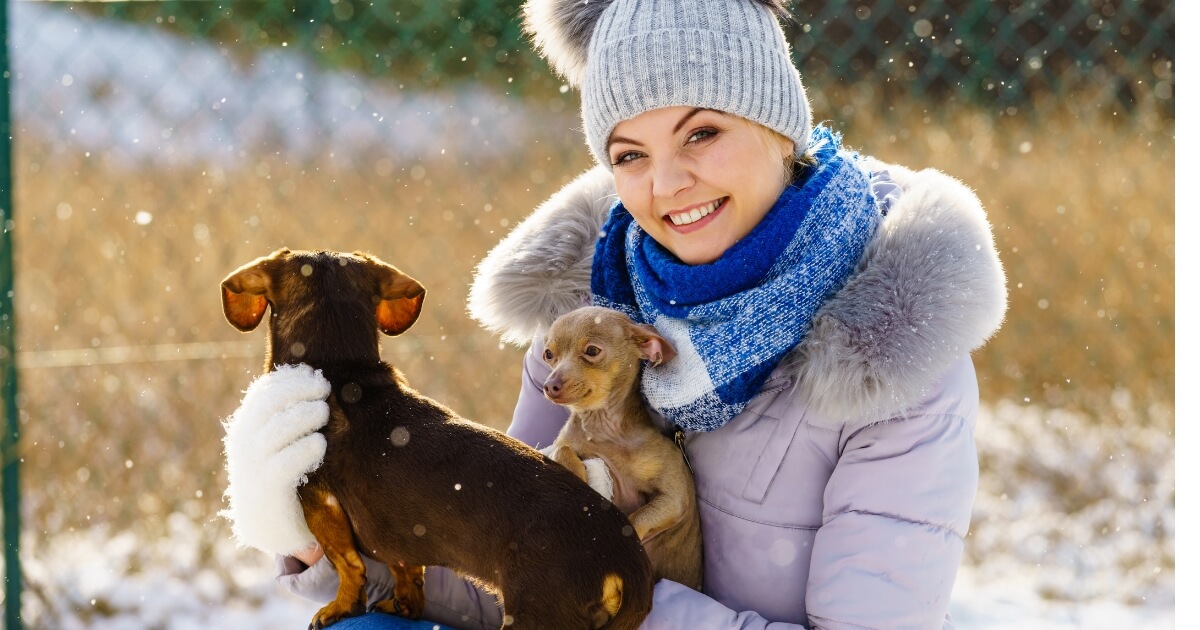 Woman outside with her pets during winter